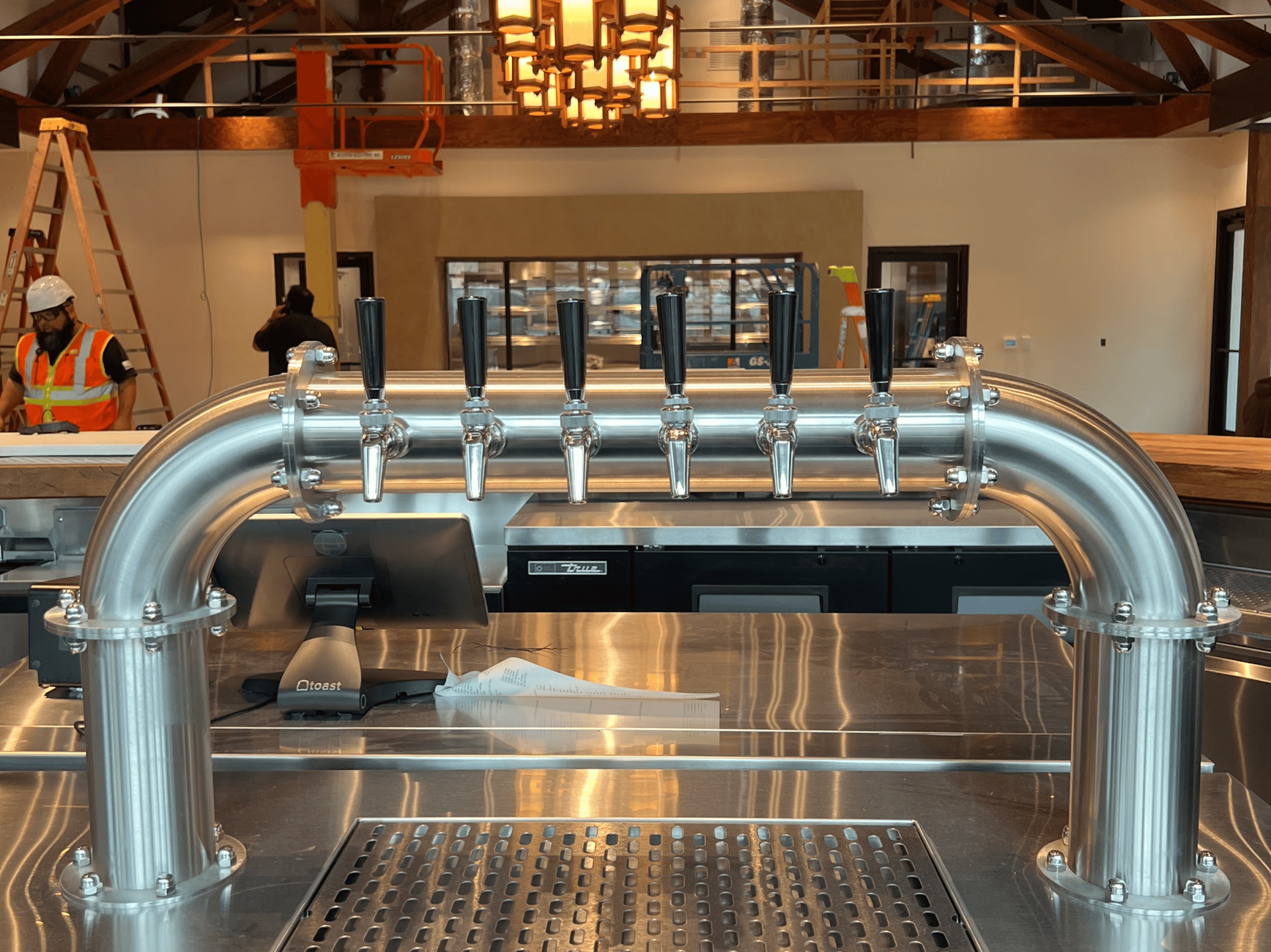Modern draft beer tap system at Example Co with stainless steel finish.