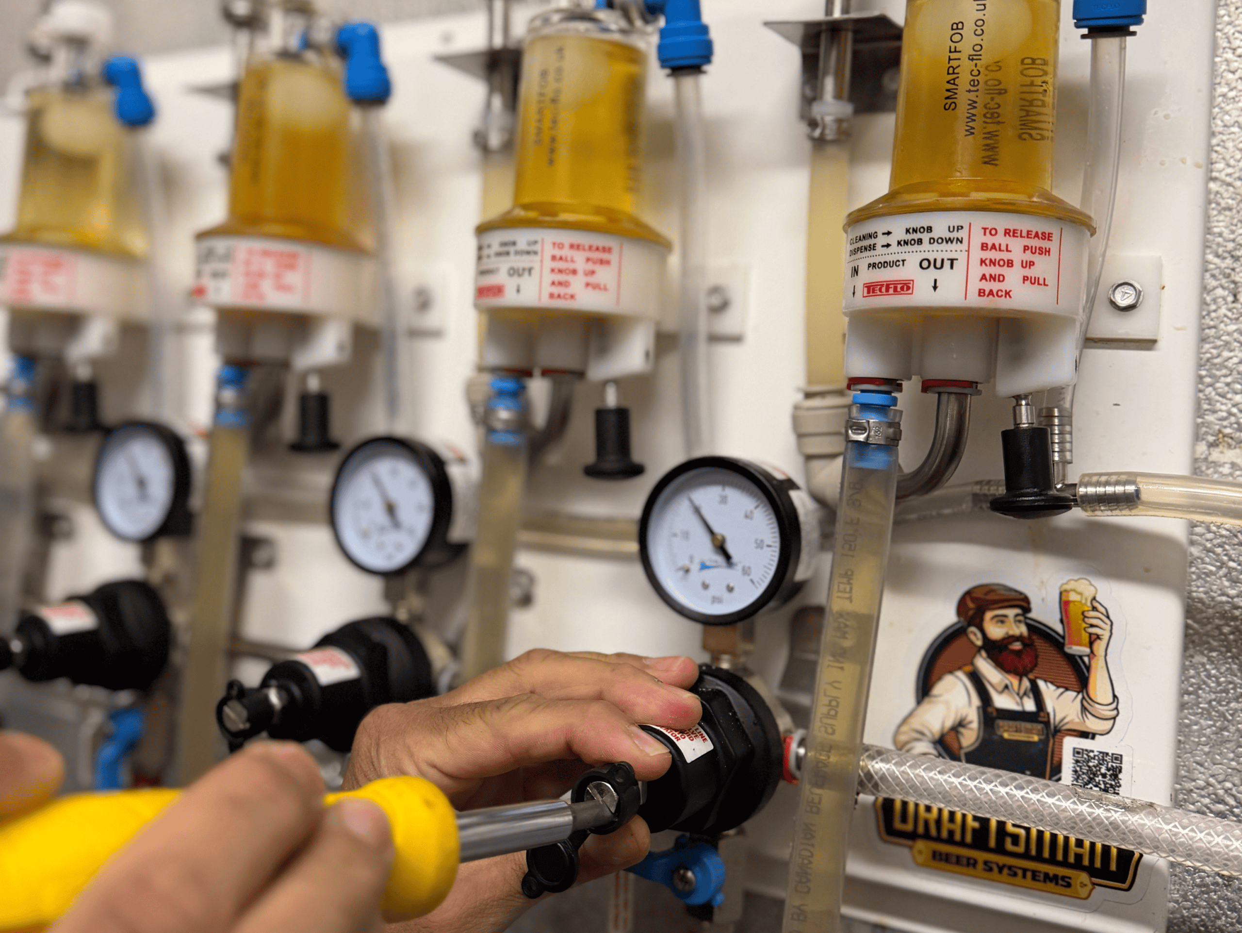 Close-up of draft beer system with gauges and taps at Example Co.